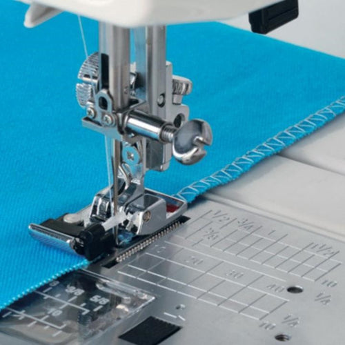 Finishing raw edges using a sewing machine - close up of sewing an overlock stitch