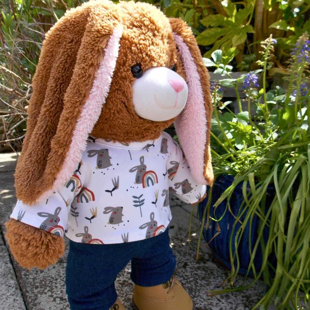 Brown Build a Bear teddy bear wearing a white patterned t-shirt & blue trousers.