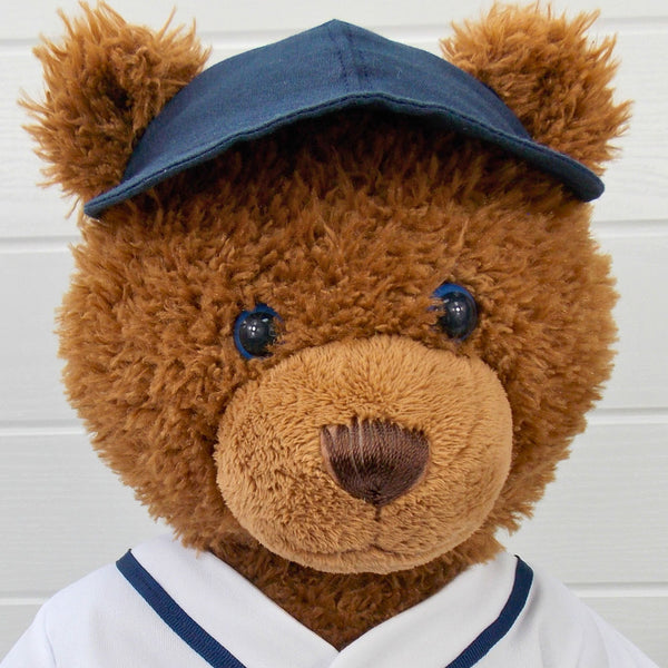 Build a bear teddy bear wearing a blue baseball cap. The teddy bear baseball cap is made from a sewing pattern by Best Dressed Bears.