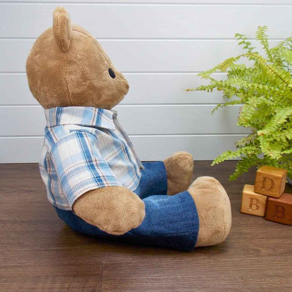 Brown Simplicity Memory Bear wearing a blue and beige striped shirt and blue trousers. The teddy bear trousers and teddy bear shirt have been made with sewing patterns from Best Dressed Bears