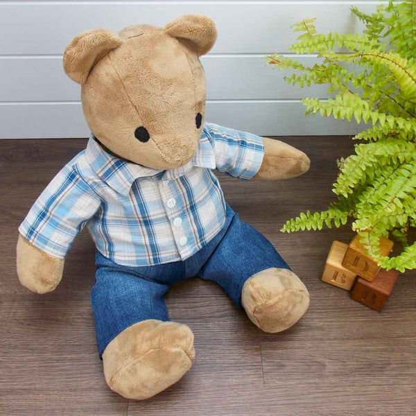 Brown Simplicity Memory Bear wearing a blue and beige striped shirt and blue trousers. The teddy bear trousers and teddy bear shirt have been made with sewing patterns from Best Dressed Bears